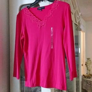 A Hot Pink long Sleeve with flowers around the collar bone